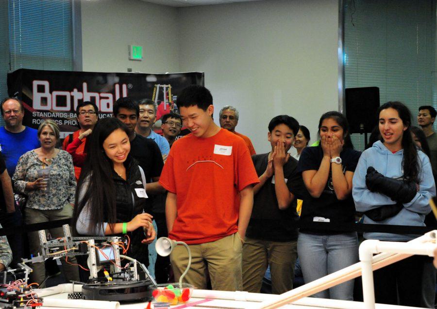 The Menlo Botball team watches on excitedly as their robot successfully completes one of the required tasks.