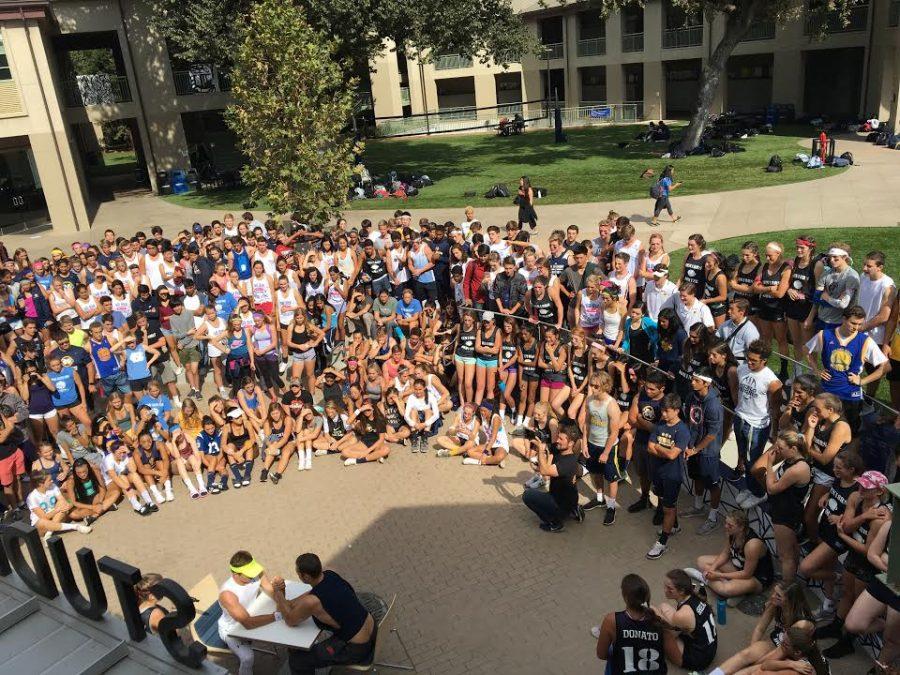 Students gather around the student center during lunch to witness the Muscle Monday spirit activities, which included a push-up contest and arm-wrestling. 