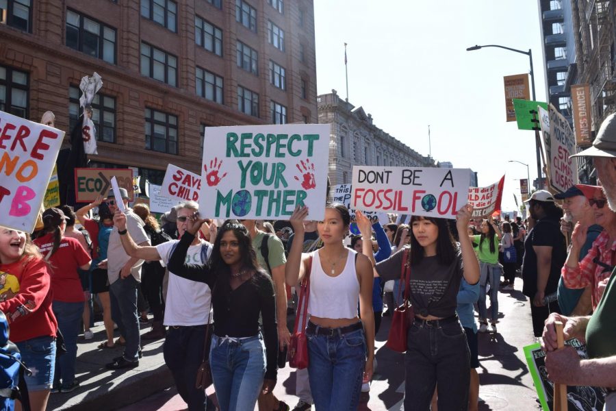 Youth march down 7th Street with signs. Staff Photo: Kate Hammond. 