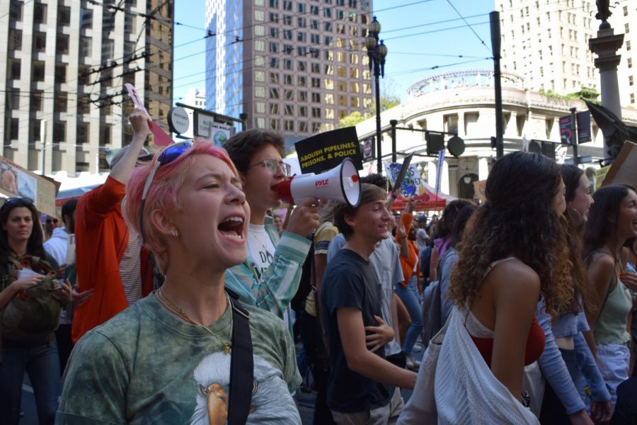 Protesters chant while marching on Market Street. Staff Photo: Kate Hammond.  