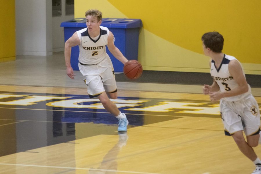 Senior Justin Sellers dribbles down the court. Photo courtesy of Doug Peck. 