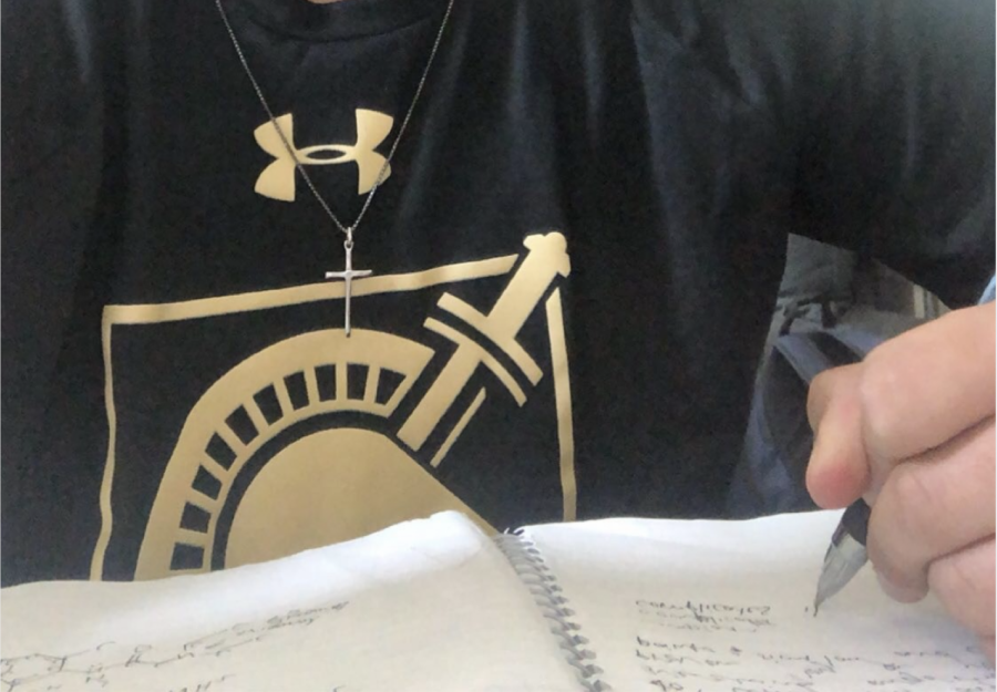 Sophomore Saaz Ahuja takes notes for his online English class at home. Photo courtesy Saaz Ahuja.
