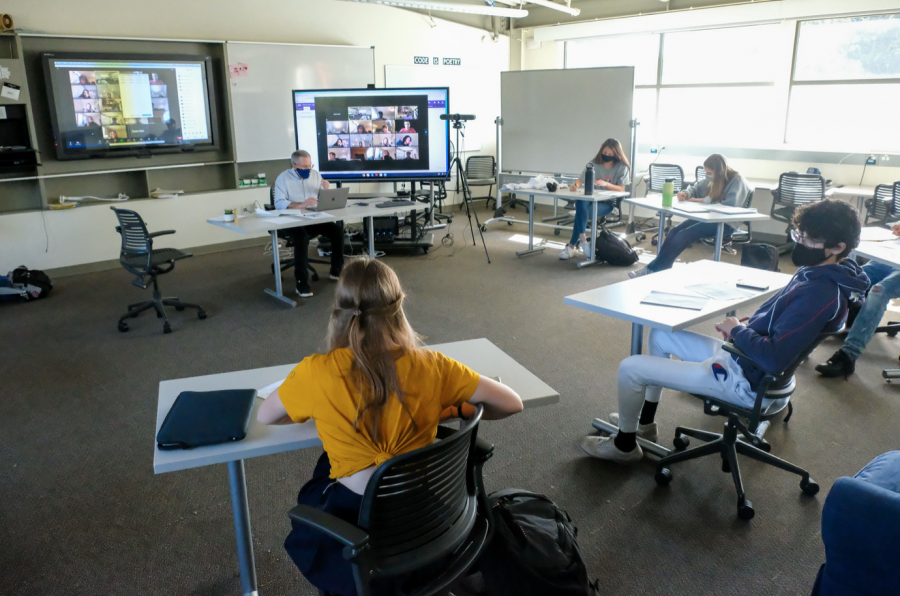 Menlo students and teachers sit socially distanced during the first round of hybrid learning in November 2020, with some students present in the classroom and some on Zoom for the lecture. Photo courtesy of Pete Zivkov.