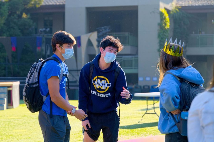 Seniors Alex Wang, Luke Yuen and Claire Ehrig greet each other on the quad during the Blue hybrid learning cohorts first week back on campus. Photo courtesy of Cyrus Lowe.