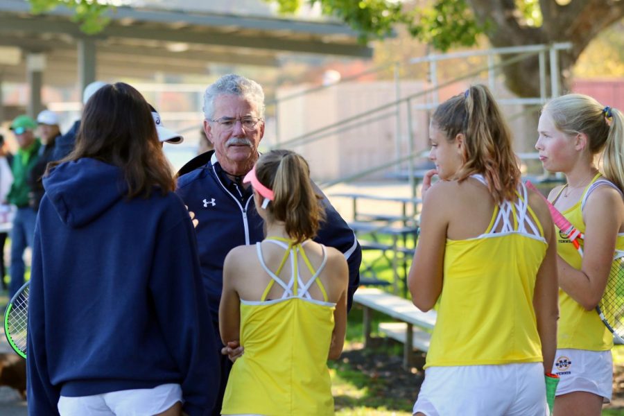 Menlo tennis coach Bill Shine coaches members of the varsity girls tennis team in between matches at the Stanford Invitational in 2019. Photo courtesy of Leon Yao.