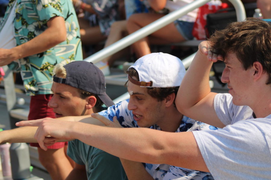 Menlo seniors, pictured left to right, Gregory Hilderbrand, Daniel Solomon and Henry Kearnan watch the first varsity football game of the season from the bleachers. Staff Photo: Alexa Friesel. 