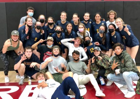 Menlo junior and senior spectators pose with members of the girls varsity volleyball team after they defeated Sacred Heart. With the win, the Knights secured a West Bay Athletic League Foothill Division championship for the first time since 2018. Photo courtesy of Kristina Israelski.