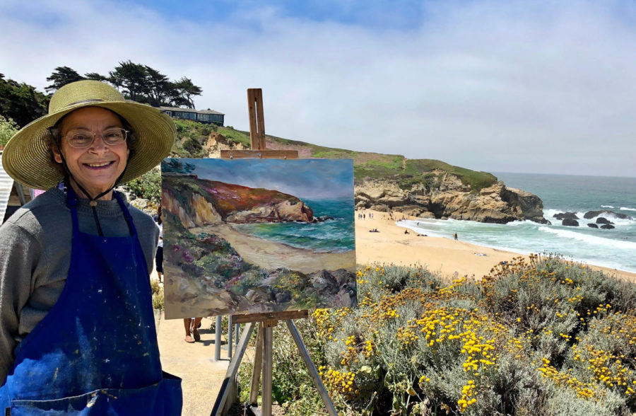 Nina+Ollikainen+smiles+for+a+photo+while+making+a+%E2%80%9Cplein+air%E2%80%9D+painting+at+Montara+Beach.+Ollikainen+often+likes+to+go+and+paint+nature.+%E2%80%9CI+love+to+be+out+in+nature%2C+go+hiking%2C+investigate+a+location+and+spend+the+day+painting+there%2C%E2%80%9D+she+said.+Photo+courtesy+of+Nina+Ollikainen.