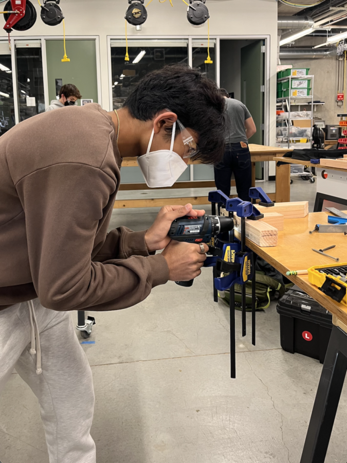 Sophomore Nikhil Chopra constructs a wooden square for his first project in Marc Allard’s Mechanical Engineering class. Staff photo: Karen Xin.