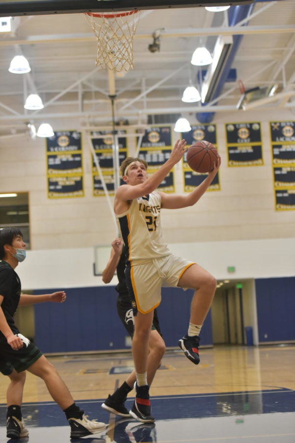 Eggemier goes for a layup against Harker on Feb. 8. His jump from his sophomore season to his junior season was huge, and he plans to keep the momentum rolling for his final dance next year. Photo Courtesy of Christine Young. 