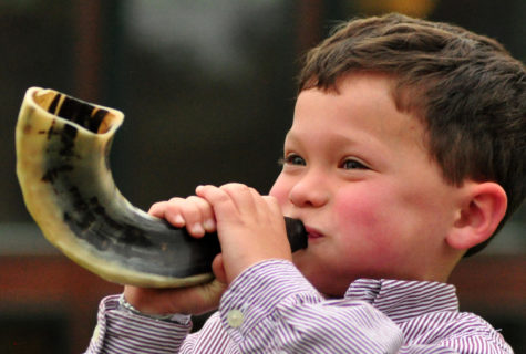 A child blows a shofar—a hollow ram’s horn—to celebrate Rosh Hashanah. Creative Commons Photo: Len Radin on Flickr