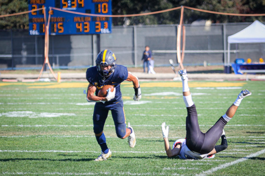 Wide Receiver Brady Jung sheds a tackle, leading to his second touchdown of the day. Staff Photo: Lexi Friesel