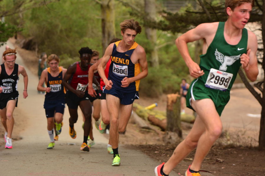 Justin Pretre (center) runs at the Lowell Invitational, with Landon Pretre (left) shortly behind. At the end of the 5k, Justin and Landon Pretre placed first and second, respectively, out of 300 runners. Photo courtesy of Steve Pretre