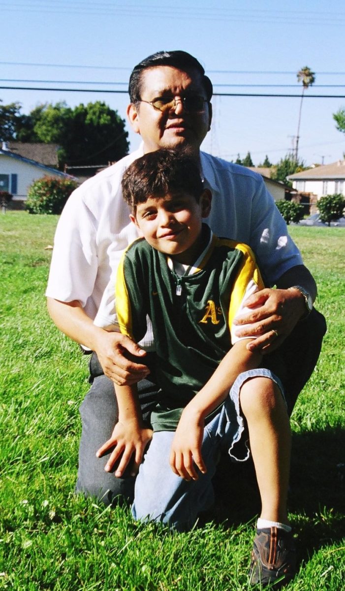 Lopez at age five in an A’s windbreaker with his grandfather in 2000. Photo courtesy of Lopez
