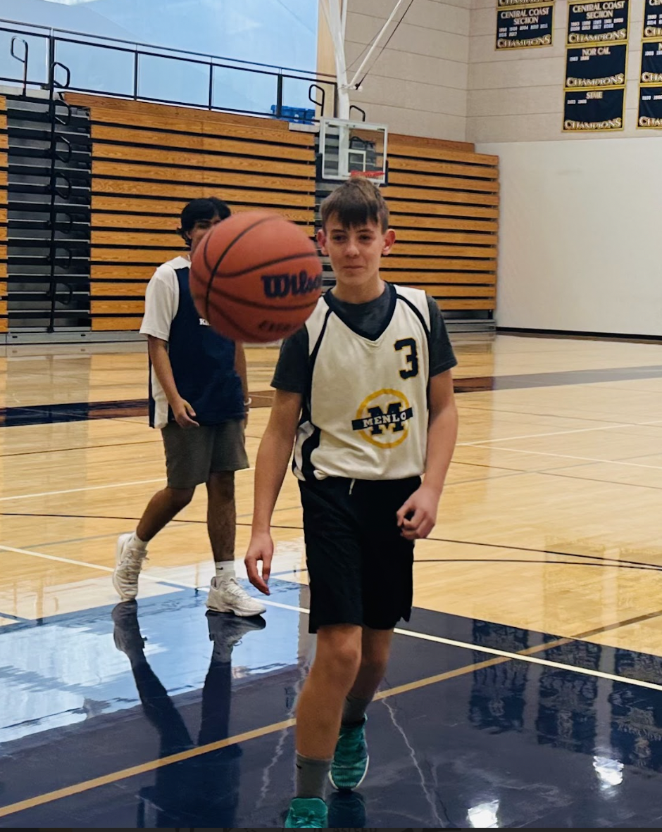 Freshman Cole Milotich goes for the rebound during his freshman boys basketball practice after school. Many winter sports, such as boys basketball, had practices and even games this Thanksgiving break. Staff photo: Aaron Widjaja