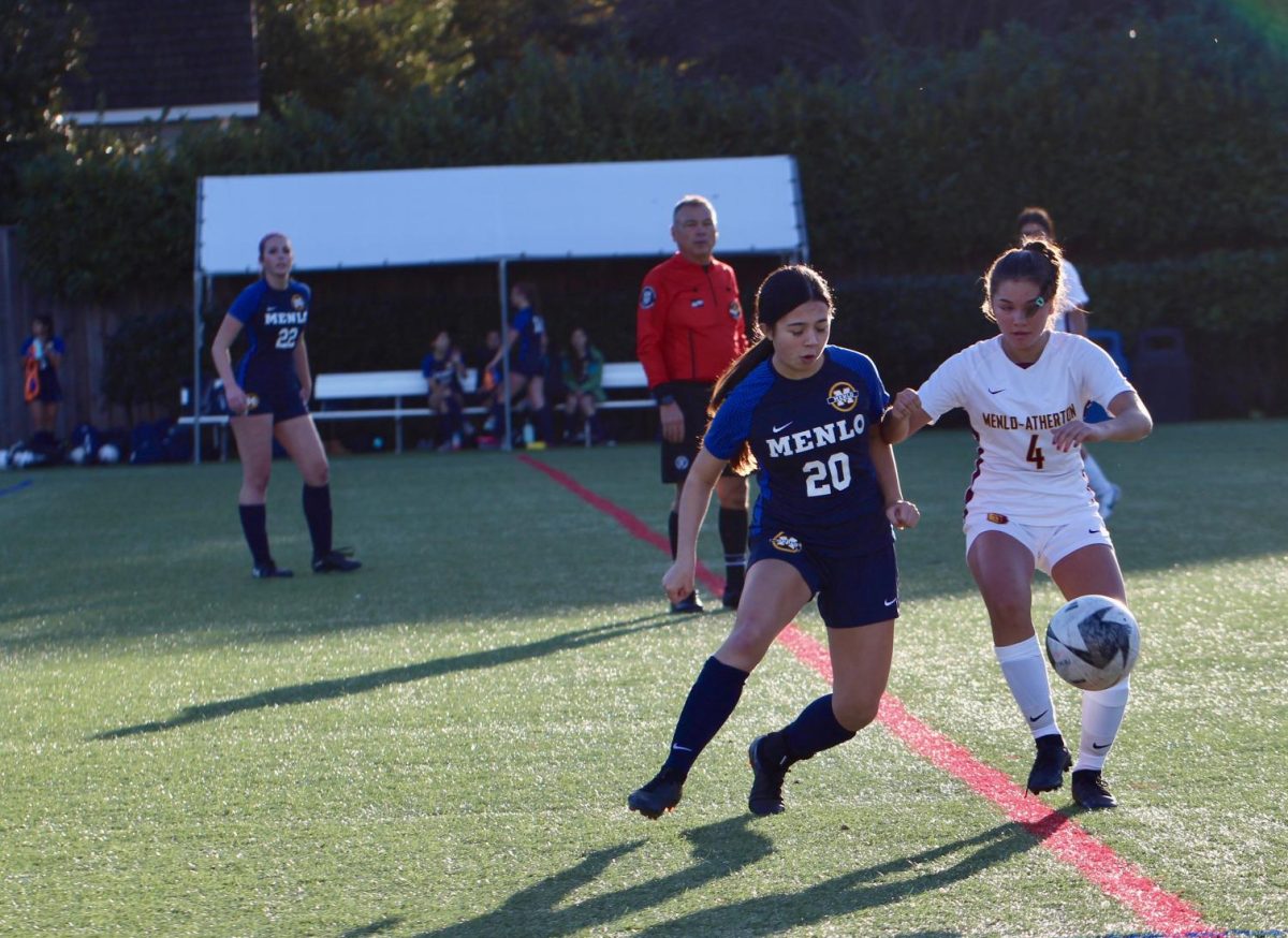 Sophomore Ella Skinner plays defense against a Bears player with the ball. Photo courtesy of Elise Chen