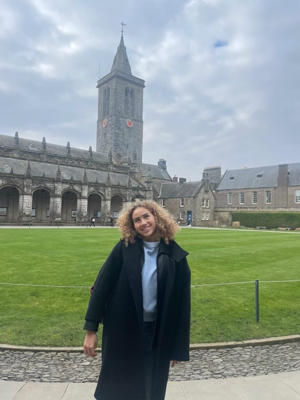 Sammie Floyd poses in front of the University of St. Andrews.
