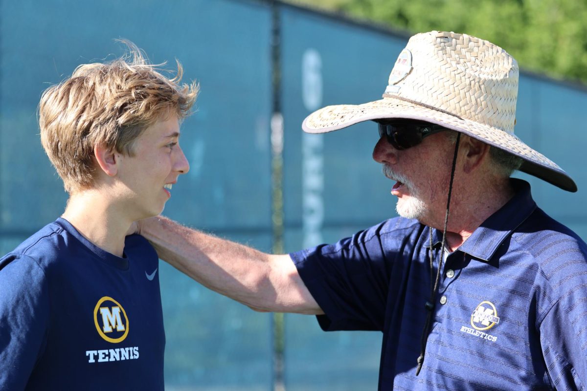 Tennis+head+coach+Bill+Shine+talks+with+senior+Octave+Moha+after+the+Knights%E2%80%99+match+against+Pinewood+School+on+April+19.