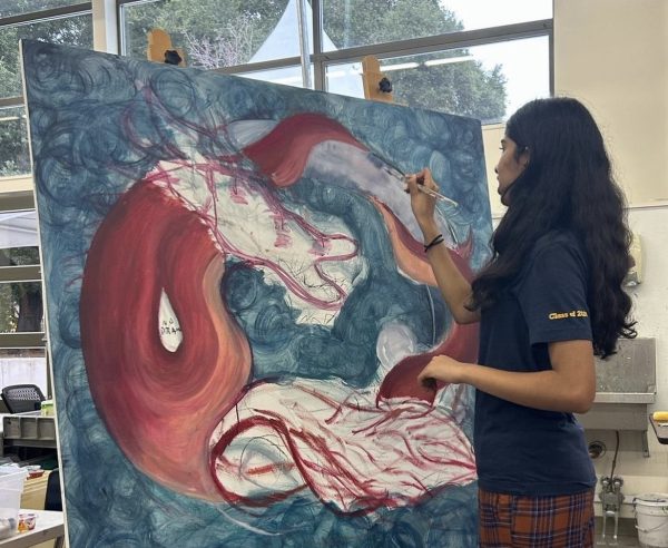 Sophomore Eisha Yadav paints the dragon mural.