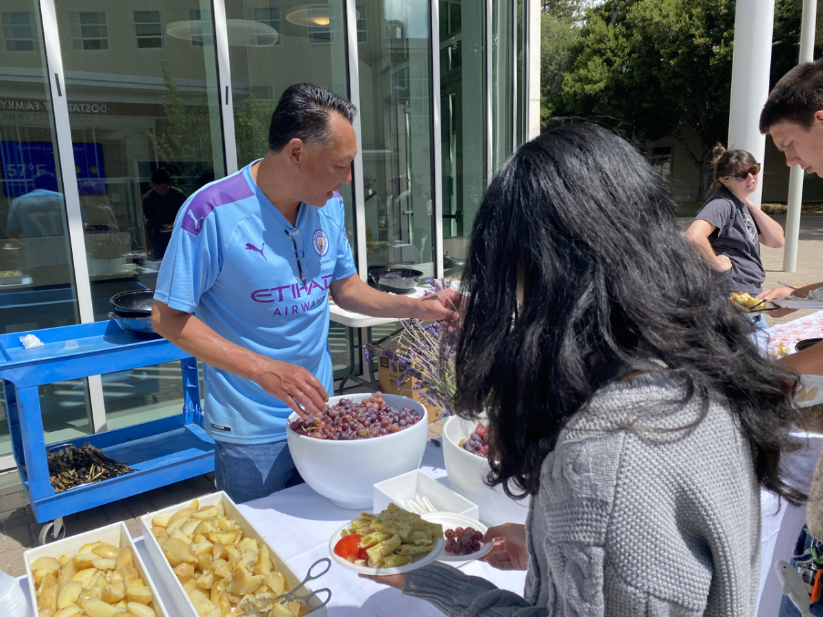 Director of Dining Services at Menlo School Thien Hoang serves students during the pop-up farmers market.