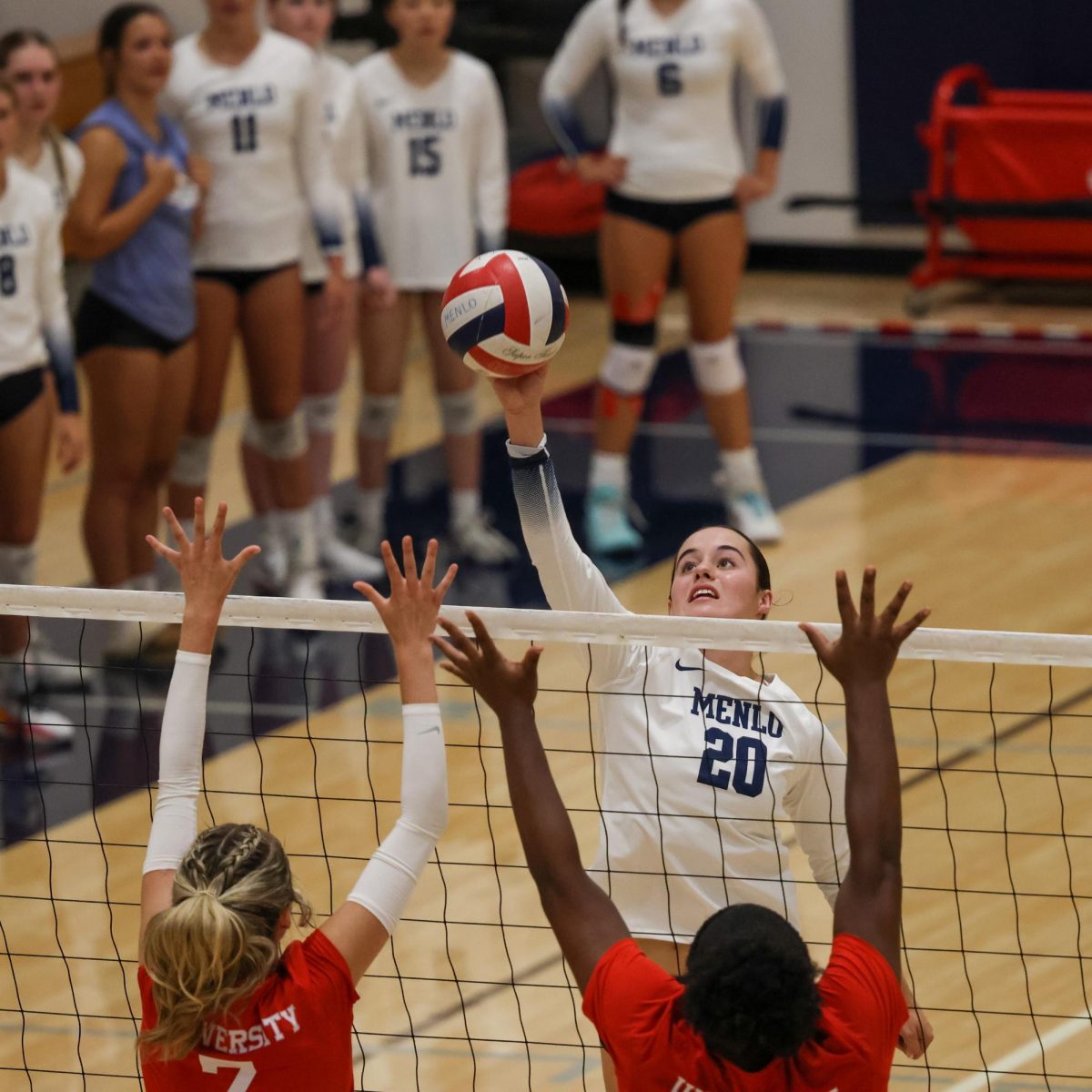 Senior Lauren Mrva tips the ball over Aragon’s blockers.