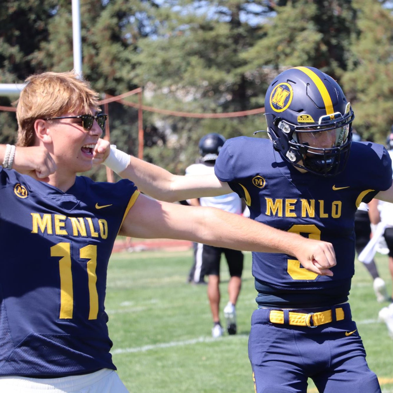 Juniors Palmer Riley (#11) and Jack Freehill (#3) celebrate together after the Knights’ opening touchdown.