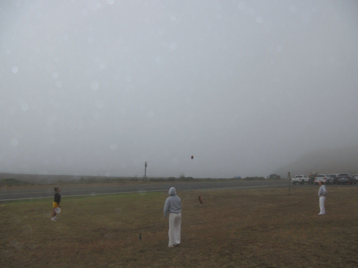 Seniors Mary Mahe, Scarlett Bundy, Julia Capasso and Ellie Knoll throw a football around during a period of free time. For their final class retreat, seniors were given ample free time on the beach and campground to talk and play amongst each other. 