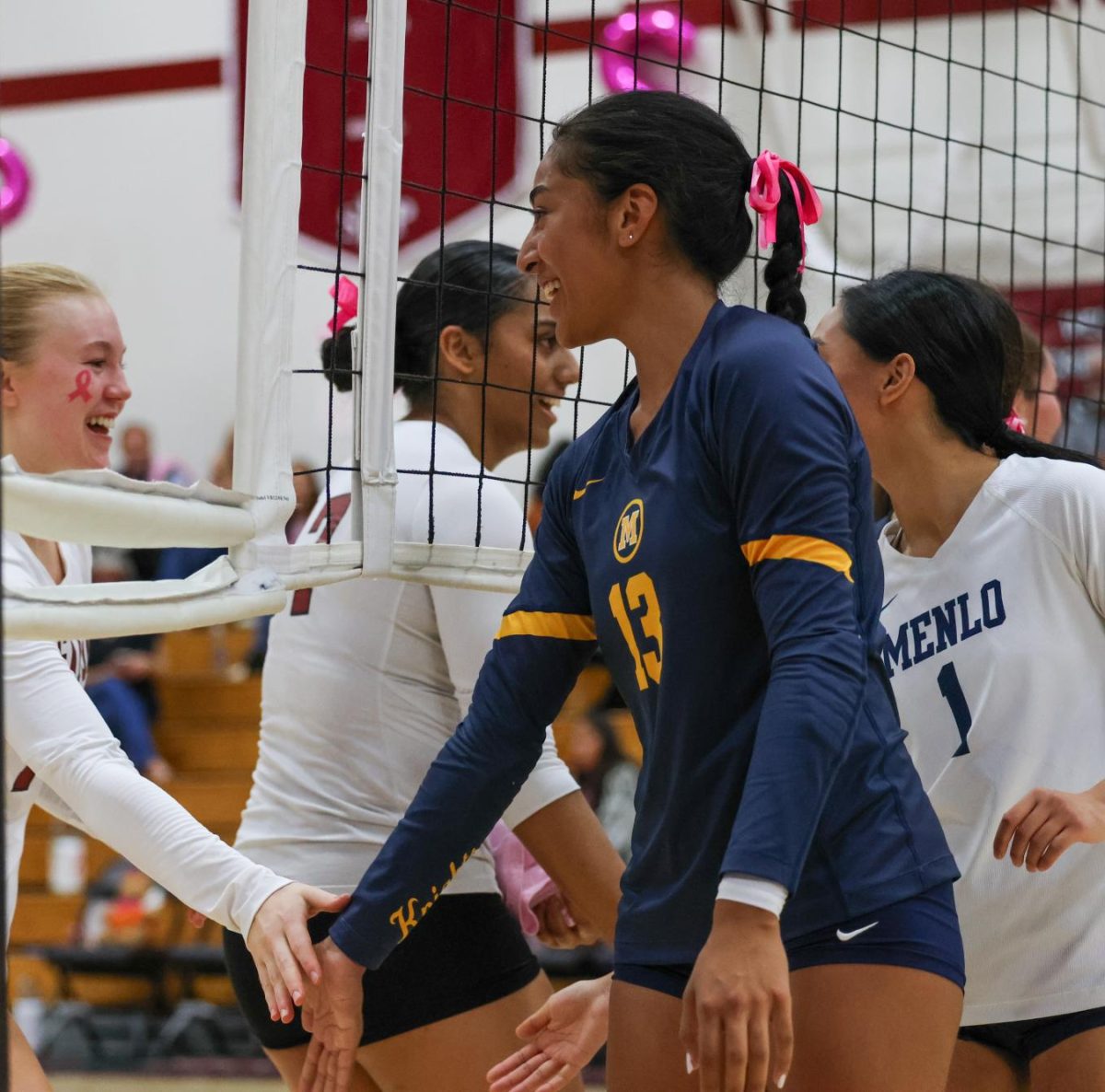 Senior Lily Kautai high-fives a SHP player’s hand before the match