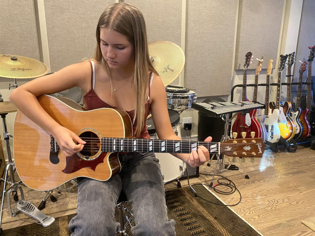 Senior Lily Nye plays a new song in her teacher’s studio. Photo courtesy of Nye.