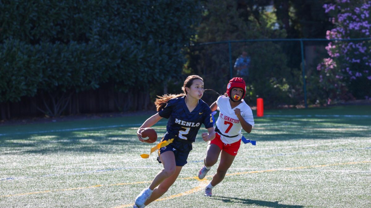 Sophomore quarterback Ava Allen runs with the ball in the Knights' game against St. Ignatius on Sept. 25.