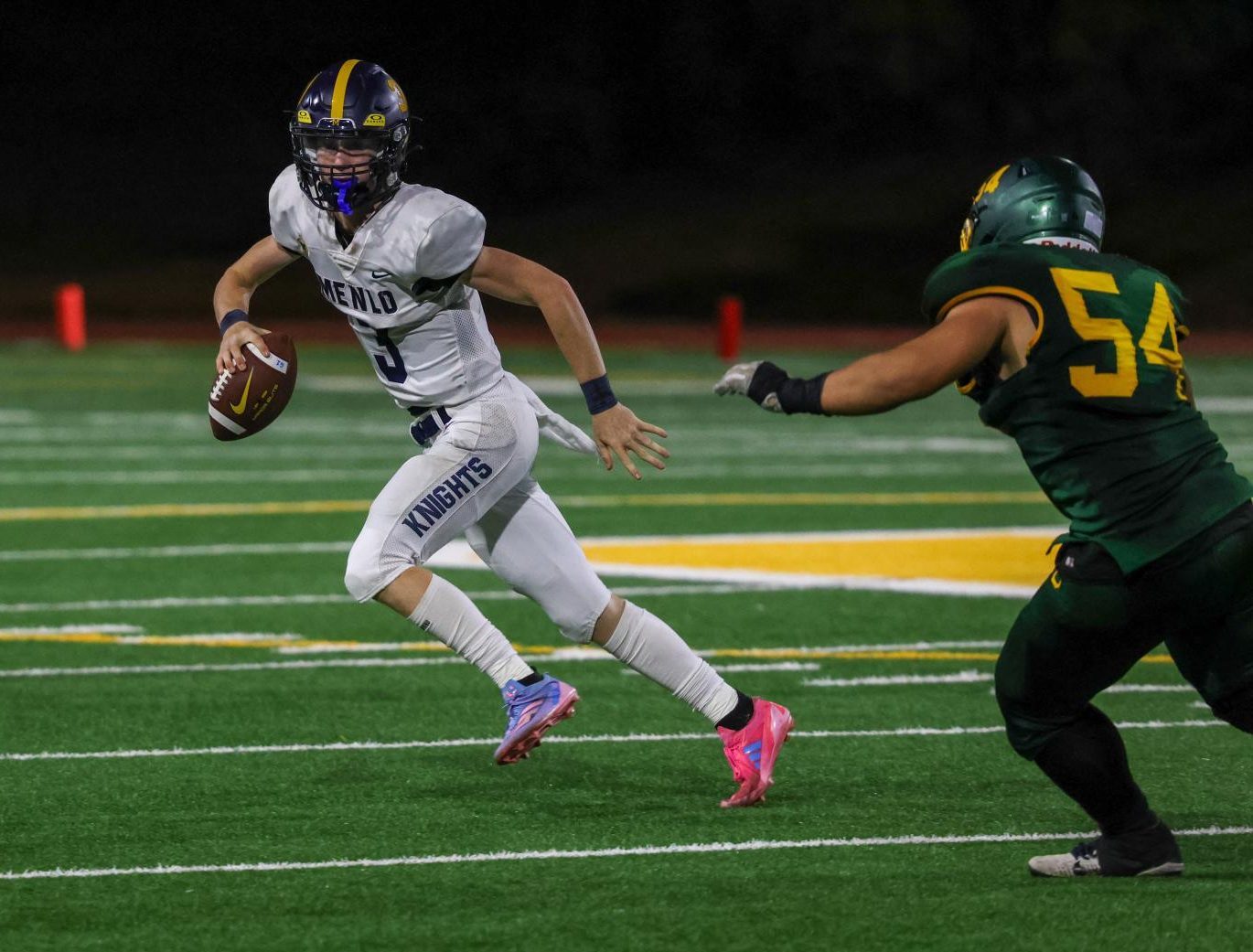 Junior quarterback Jack Freehill runs with the ball in the Knights’ game against Capuchino High School on Sept. 21.