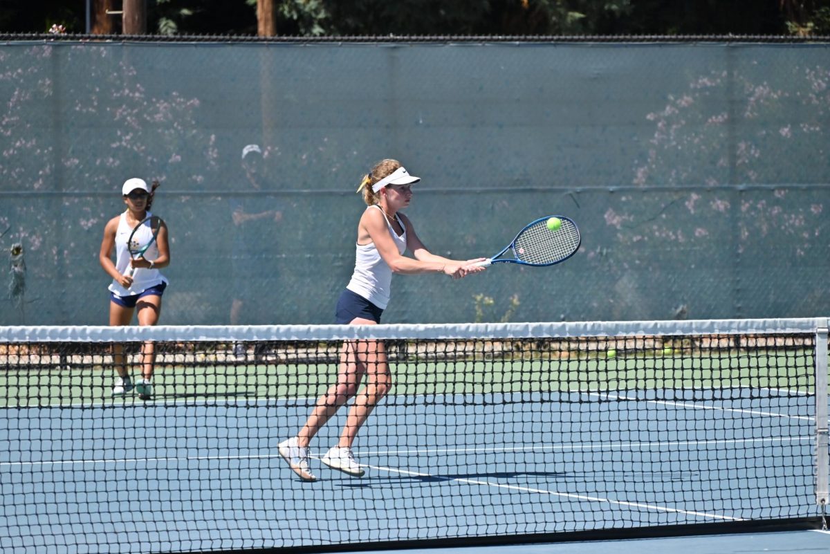 Senior Sofia Faris poaches in a doubles match at the Golden State Classic on Sept. 7. Photo courtesy of Karim Faris.