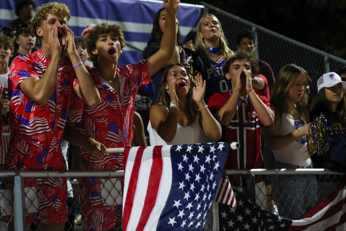 Sea of Gold Captain Tate Cohen, on the very left, leads cheers at Menlo's football game against Los Altos on Sept. 13.