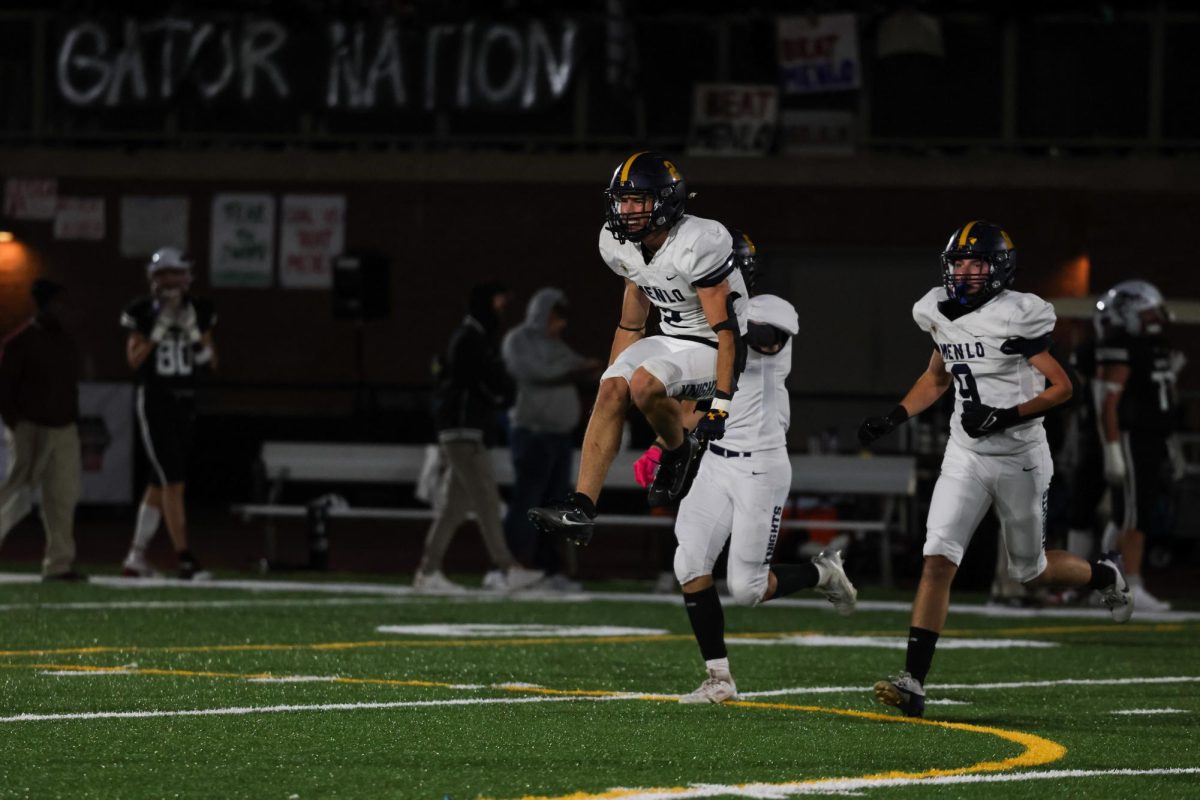 Senior Jack Enright leaps in the air after the Knights stop the Gators on fourth down when SHP faked a punt.