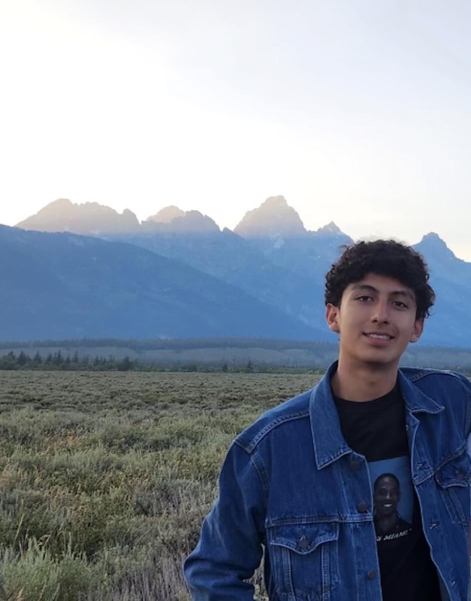 Junior Adrian Collantes posing in front of the Teton mountain range in Wyoming. Photo courtesy of Collantes.