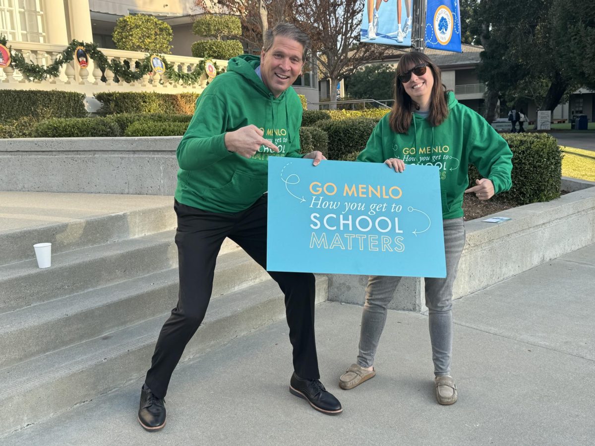 Head of School Than Healy and Director of Sustainability Chrissy Orangio welcome students during Green Ride Wednesday.