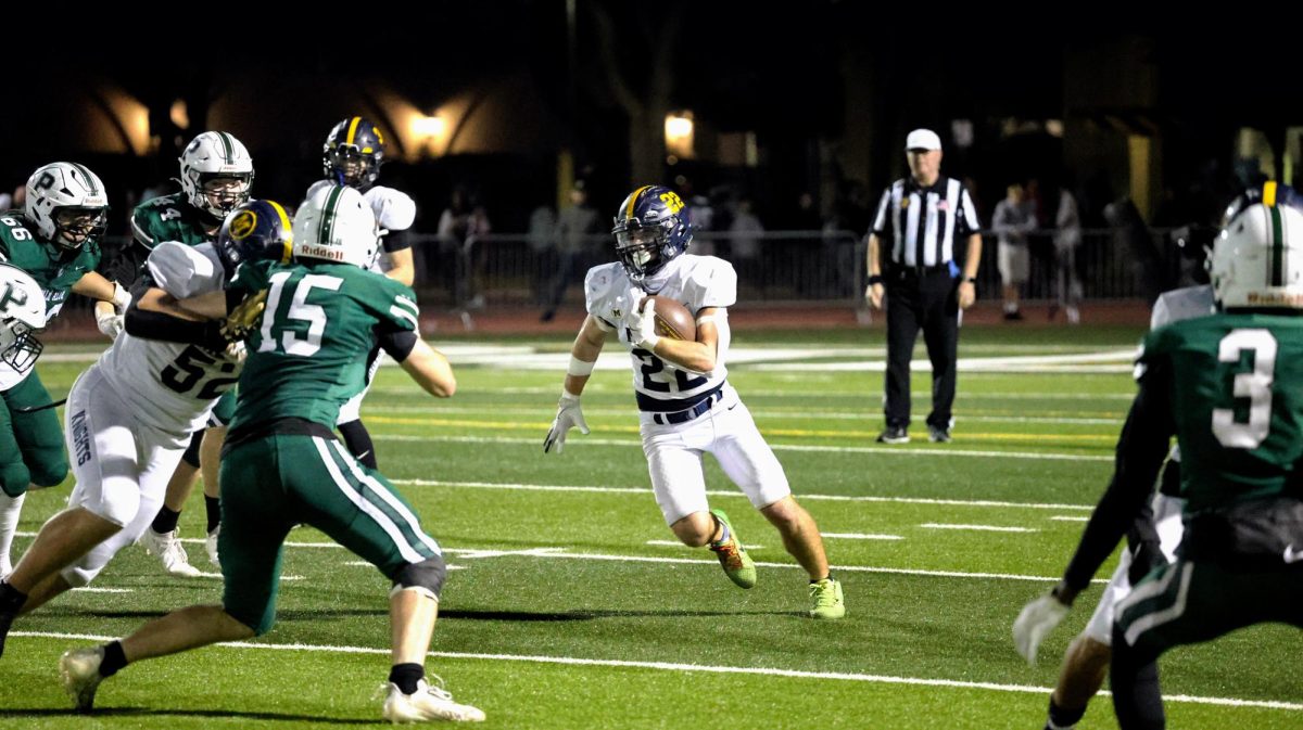 Senior running back Chuck Wynn (#22) cuts upfield on his way to a first down.