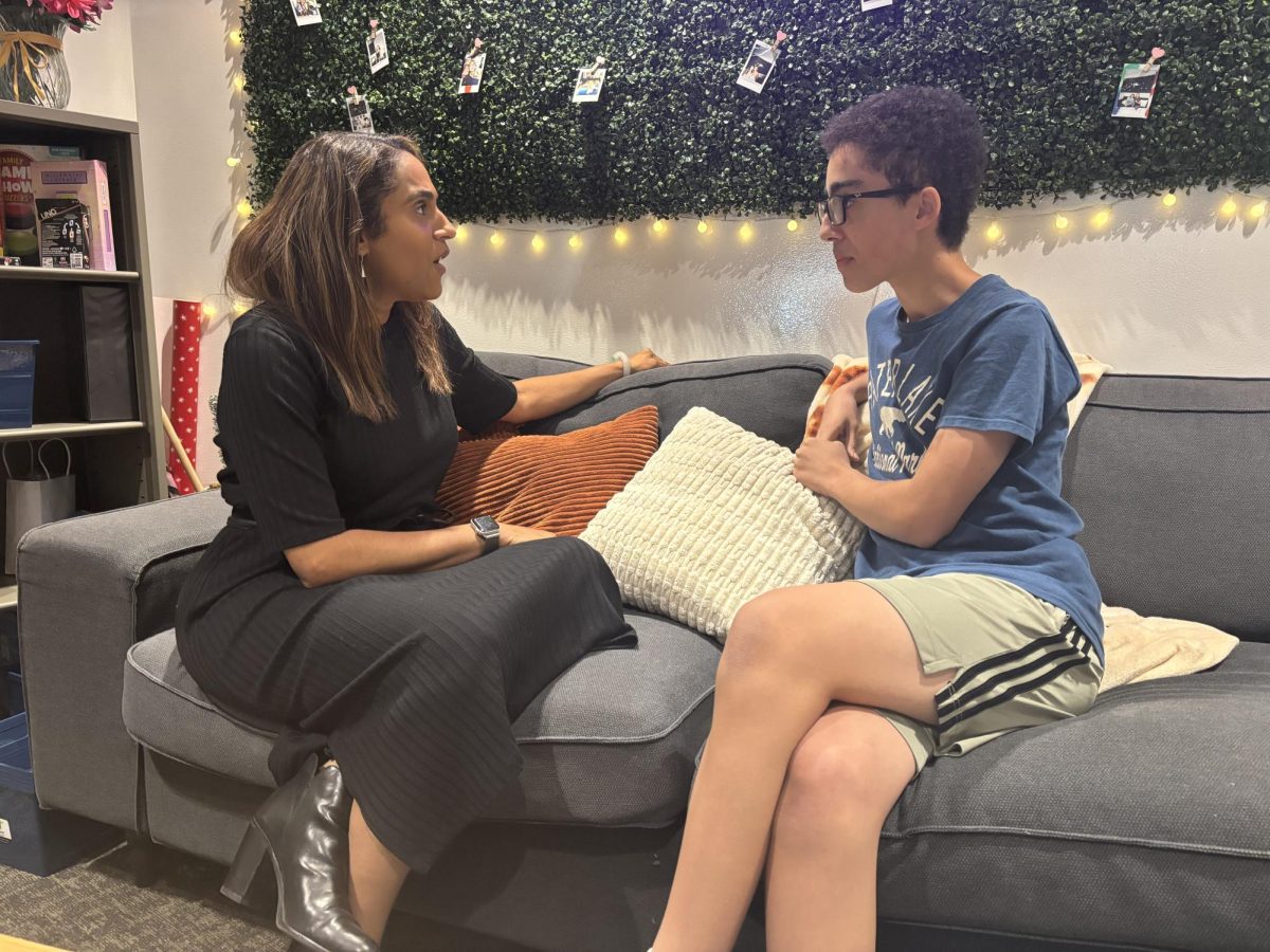 Director of Equity, Diversity, Inclusion and Belonging Carmen Borbón talks with sophomore Wanis Moutri. 
